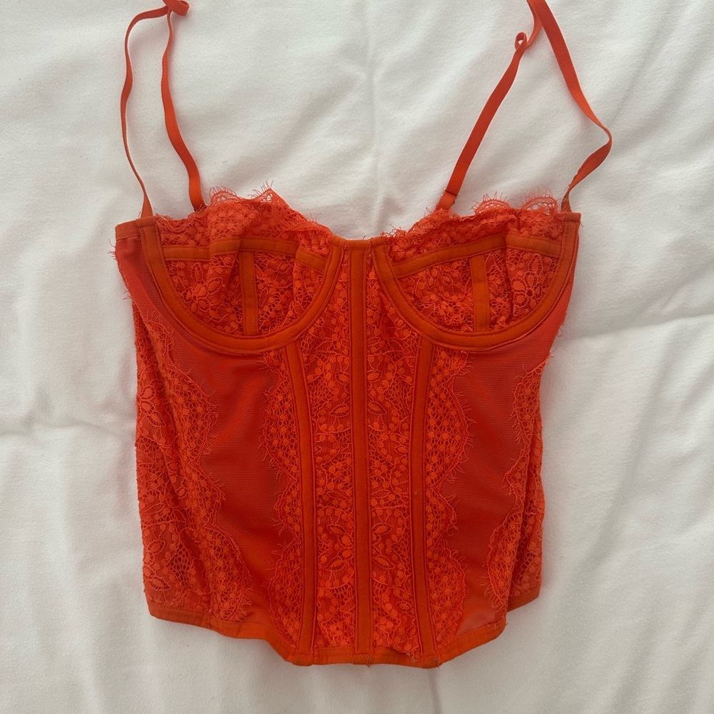 Out from under orange lace corset